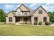 Charming stone-and-wood home featuring a covered front porch and well-manicured lawn at 174 Bellingshire Dr, Mt Ulla, NC 28125