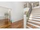 Elegant foyer showcasing a staircase with iron railing and hardwood flooring at 174 Bellingshire Dr, Mt Ulla, NC 28125