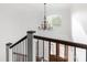 Bright foyer with a decorative chandelier, hardwood door, and open staircase at 174 Bellingshire Dr, Mt Ulla, NC 28125