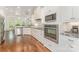 Bright kitchen with white cabinetry, stainless appliances, and hardwood flooring at 174 Bellingshire Dr, Mt Ulla, NC 28125