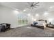 Spacious main bedroom with tray ceiling, large window, chair, and a ceiling fan at 174 Bellingshire Dr, Mt Ulla, NC 28125
