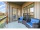 Inviting covered patio with comfortable seating and natural light through the large windows at 174 Bellingshire Dr, Mt Ulla, NC 28125
