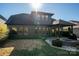 Dark gray house back with covered patio, firepit, and landscaping at 2221 Lexington St, Belmont, NC 28012