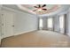 Generously sized bedroom offers multiple windows, plush carpet, and a tray ceiling at 546 Little Cove Ln, Lake Wylie, SC 29710