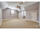 A cozy bedroom with carpet flooring, a ceiling fan, and two windows at 546 Little Cove Ln, Lake Wylie, SC 29710