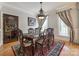 Formal dining room with hardwood floors, elegant drapes, and a decorative chandelier at 546 Little Cove Ln, Lake Wylie, SC 29710