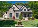Beautiful stone and stucco home with a manicured front yard and a charming water fountain at 546 Little Cove Ln, Lake Wylie, SC 29710