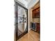 Convenient wine nook featuring custom cabinetry, a wine cooler, and a decorative glass door at 546 Little Cove Ln, Lake Wylie, SC 29710