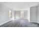 Well-lit bedroom featuring grey flooring and two large windows at 105 Center St, Kings Mountain, NC 28086