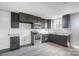 Modern kitchen with dark cabinetry, stainless steel appliances, and granite countertops at 105 Center St, Kings Mountain, NC 28086