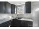 Modern kitchen with dark cabinets, granite countertops, and a double sink at 105 Center St, Kings Mountain, NC 28086