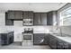 Modern kitchen featuring dark gray cabinets, stainless steel appliances, and granite countertops at 105 Center St, Kings Mountain, NC 28086