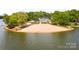 Sandy beach with lake access and a playground at 108 Elm St, New London, NC 28127