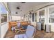 Relaxing screened porch with wooden furniture and ceiling fans at 108 Elm St, New London, NC 28127