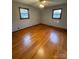 Hardwood floor bedroom with two windows and ceiling fan at 112 Adcock St, Belmont, NC 28012