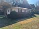 Side view of ranch home showcasing landscaping at 112 Adcock St, Belmont, NC 28012