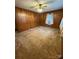 Living room featuring wood paneled walls and carpet at 112 Adcock St, Belmont, NC 28012