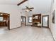 Bright living room with a brick fireplace, beamed ceiling, and wood-look flooring at 1805 Tufnell Ct, Charlotte, NC 28262