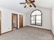 Main bedroom featuring vaulted ceiling, ceiling fan and an arched window at 1805 Tufnell Ct, Charlotte, NC 28262