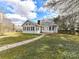 Rear exterior featuring many windows, brick chimney and a fenced in yard at 1805 Tufnell Ct, Charlotte, NC 28262