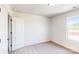 Well-lit bedroom featuring carpeted floors and a large window at 2078 Van Buren Rd, Sherrills Ford, NC 28673