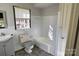 Bathroom with a tub, toilet, and gray vanity at 602 W Graham St, Shelby, NC 28150