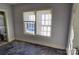 Small bedroom with hardwood floors, a window, and a view of a nearby bathroom at 602 W Graham St, Shelby, NC 28150