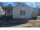 Side view of a white sided house with a small patio and driveway at 602 W Graham St, Shelby, NC 28150