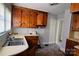 Kitchen with wooden cabinets, a double sink, and vinyl flooring at 602 W Graham St, Shelby, NC 28150