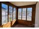 Bright sunroom with wood paneling and ample windows at 602 W Graham St, Shelby, NC 28150