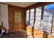 Sunroom featuring wood walls, door, and windows at 602 W Graham St, Shelby, NC 28150