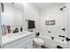 Bright bathroom featuring a white vanity, toilet, tub with shower, and matte black fixtures at 625 Charles St, Rockwell, NC 28138