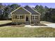 Charming single-story home with wood siding, covered porch, and manicured front yard at 625 Charles St, Rockwell, NC 28138