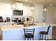 Bright kitchen features white cabinets, stainless steel appliances, and a quartz countertop island with bar stool seating at 625 Charles St, Rockwell, NC 28138