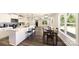 Bright, open-concept kitchen and dining area with white cabinets, black pendant lights, and wood floors at 625 Charles St, Rockwell, NC 28138