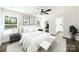 Sunlit primary bedroom with a ceiling fan, walk-in closet, and ensuite bathroom access at 625 Charles St, Rockwell, NC 28138