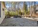 Expansive stone patio with mature landscaping creates an outdoor living area with privacy and charm at 917 Patrick Johnston Ln, Davidson, NC 28036