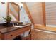 Charming bathroom with wood paneling, granite counters, vessel sink, and decorative mirror adds rustic elegance at 917 Patrick Johnston Ln, Davidson, NC 28036