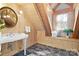 Bright bathroom featuring wood walls, a window seat, and natural light at 917 Patrick Johnston Ln, Davidson, NC 28036