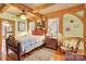 Bedroom with wooden ceiling beams and rocking chair at 917 Patrick Johnston Ln, Davidson, NC 28036