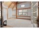 Bright room with a large window, wood trim, vaulted ceilings, and built in shelving offers a cozy retreat at 917 Patrick Johnston Ln, Davidson, NC 28036