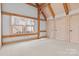 Bright bedroom featuring wood beams, large window and spacious carpeted area at 917 Patrick Johnston Ln, Davidson, NC 28036