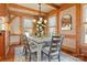 Bright dining room with wood floors, a statement chandelier, and plenty of natural light at 917 Patrick Johnston Ln, Davidson, NC 28036