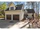 Charming house exterior with two car garage, complemented by stone pathway and mature trees at 917 Patrick Johnston Ln, Davidson, NC 28036