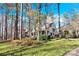 Two-story house with wrap-around porch, nestled among tall trees at 917 Patrick Johnston Ln, Davidson, NC 28036