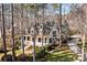 Inviting two-story home with a charming front porch, landscaped yard, and mature trees at 917 Patrick Johnston Ln, Davidson, NC 28036