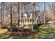 Inviting two-story home with a charming front porch, landscaped yard, and mature trees at 917 Patrick Johnston Ln, Davidson, NC 28036