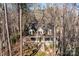 Two-story home with a charming front porch, dormer windows, and mature trees at 917 Patrick Johnston Ln, Davidson, NC 28036