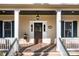 Inviting front porch with decorative stained glass door, sidelights, and view of address at 917 Patrick Johnston Ln, Davidson, NC 28036