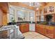 Well-lit kitchen featuring wood cabinets, granite countertops and stainless steel appliances at 917 Patrick Johnston Ln, Davidson, NC 28036